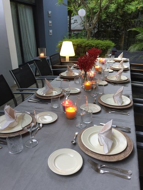 An elegant outdoor dinner table set for a group at a restaurant.
